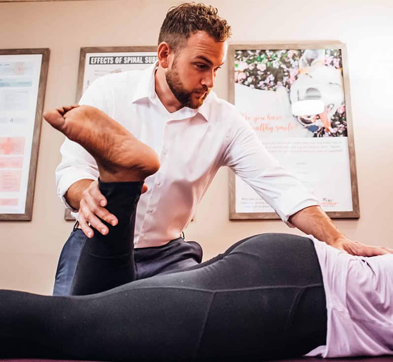 Dr. Sam treating a patient for sciatica knee pain