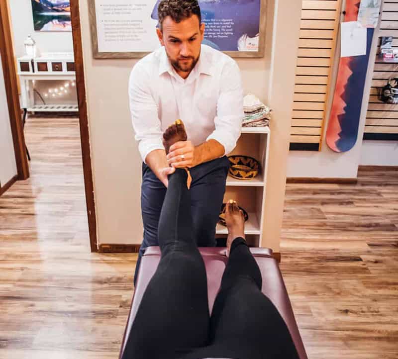 Dr. Sam treating a patient for knee pain